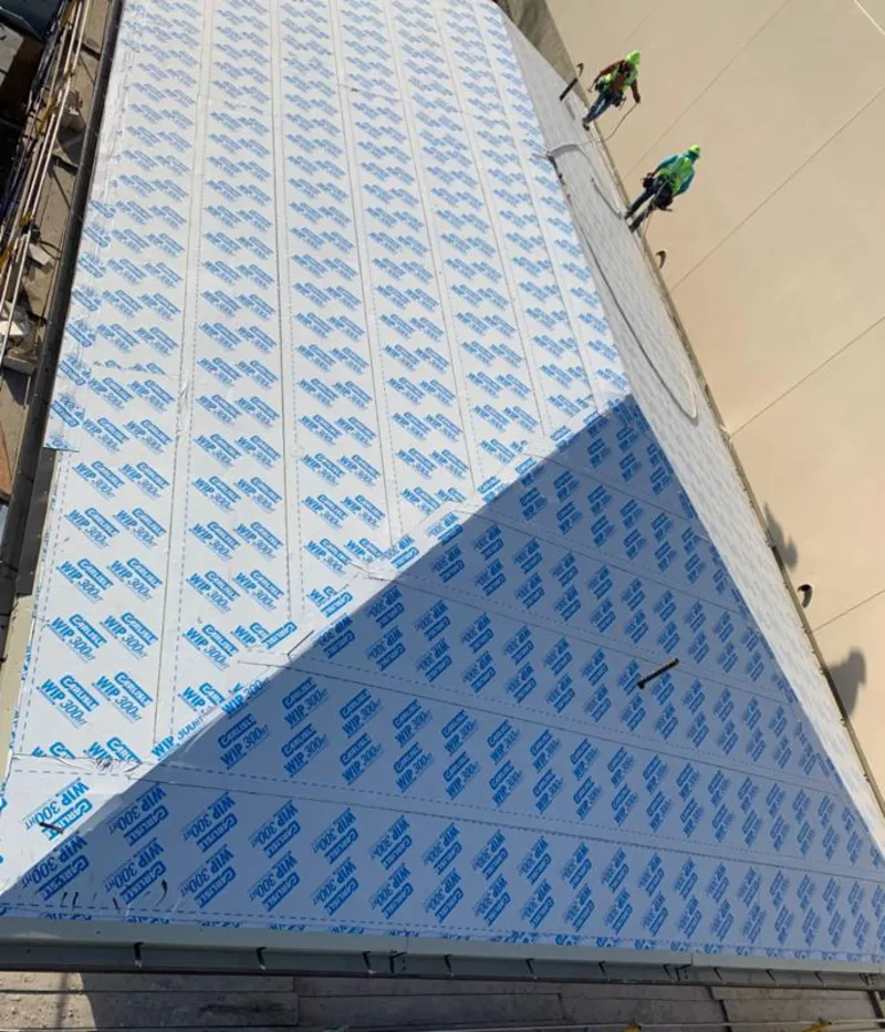 Professional roofers installing underlayment on a metal roof in Mansfield